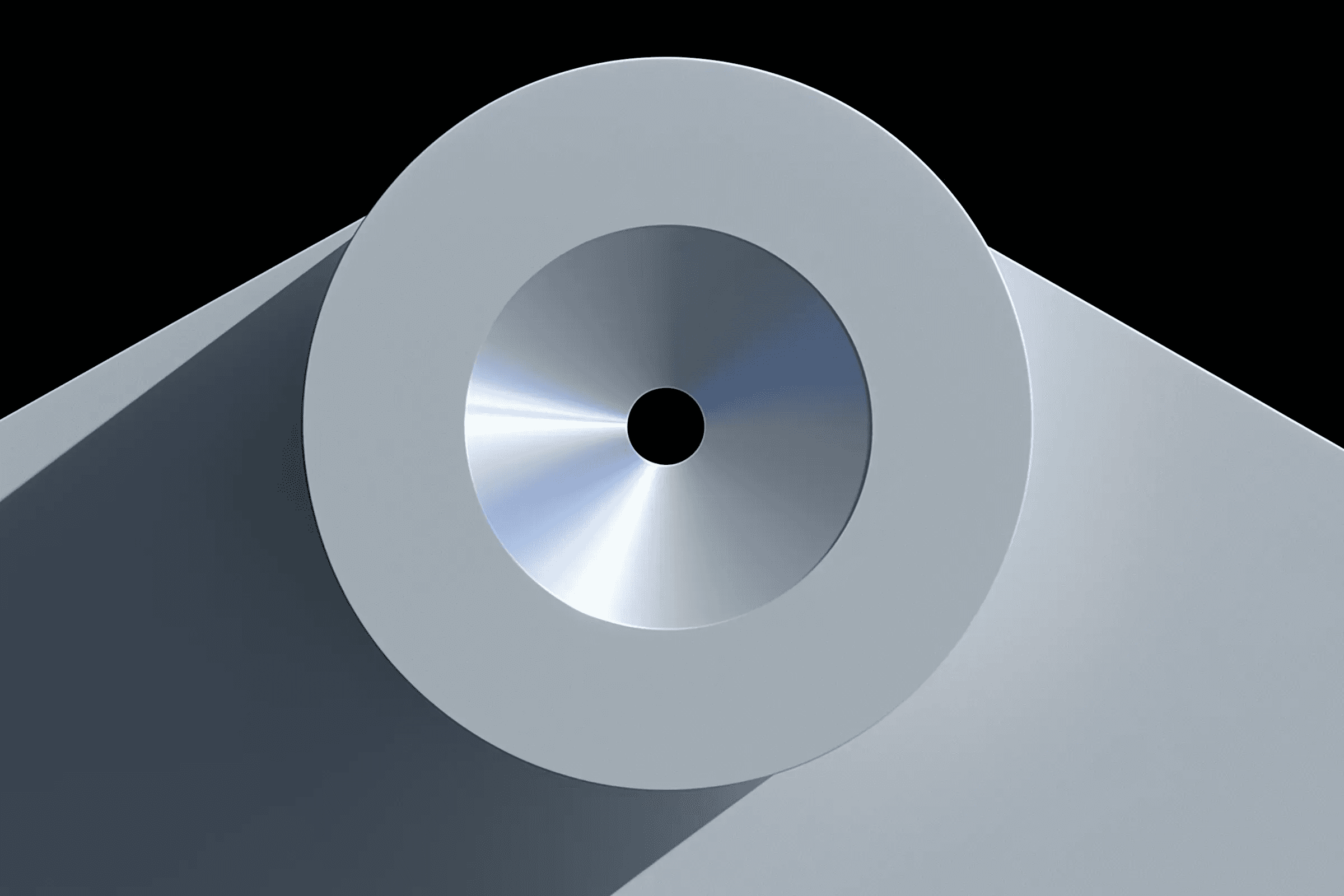 Close up of circular metal aperture on grey device surface