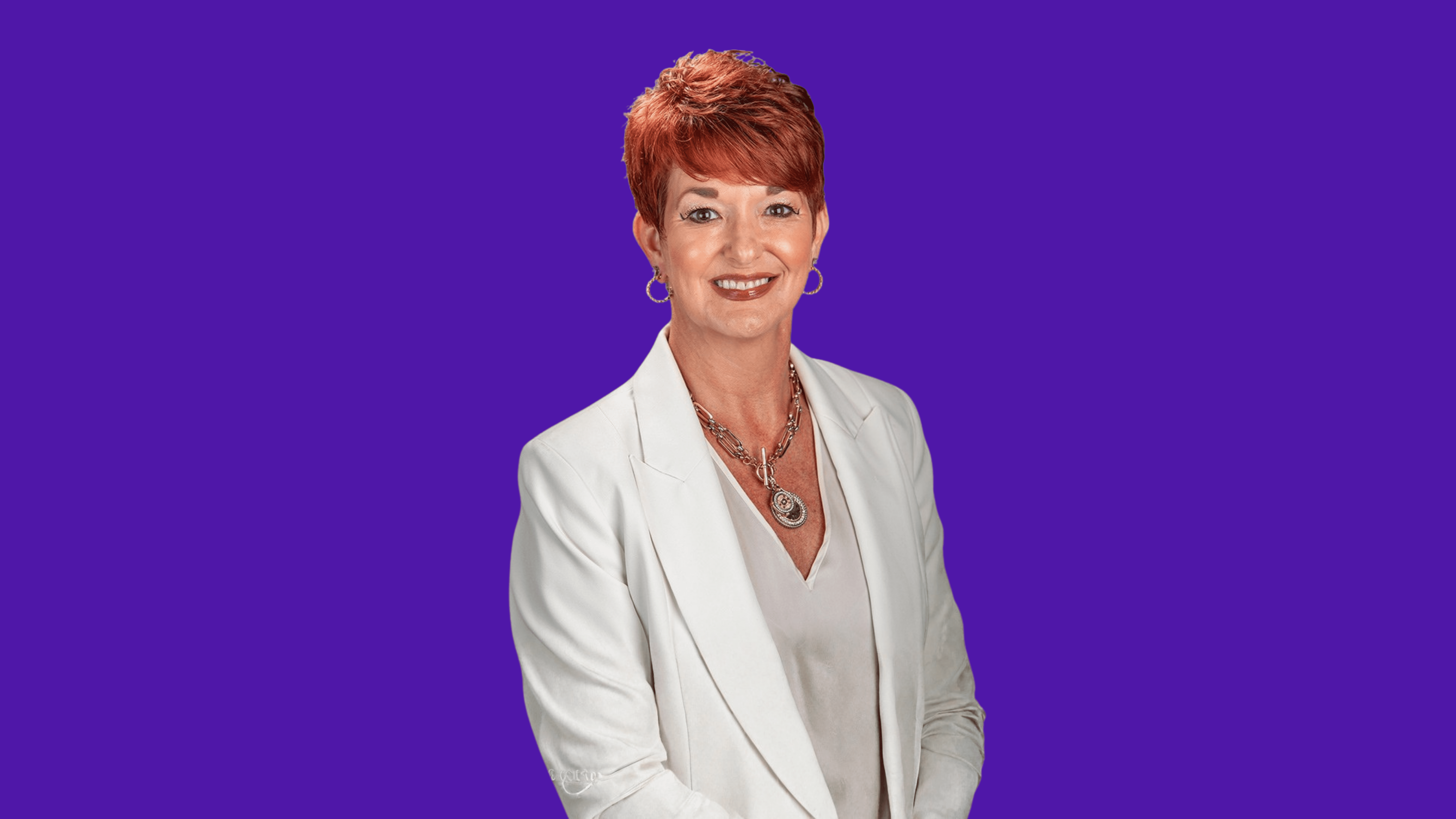 Black and white portrait of a smiling person with curly hair