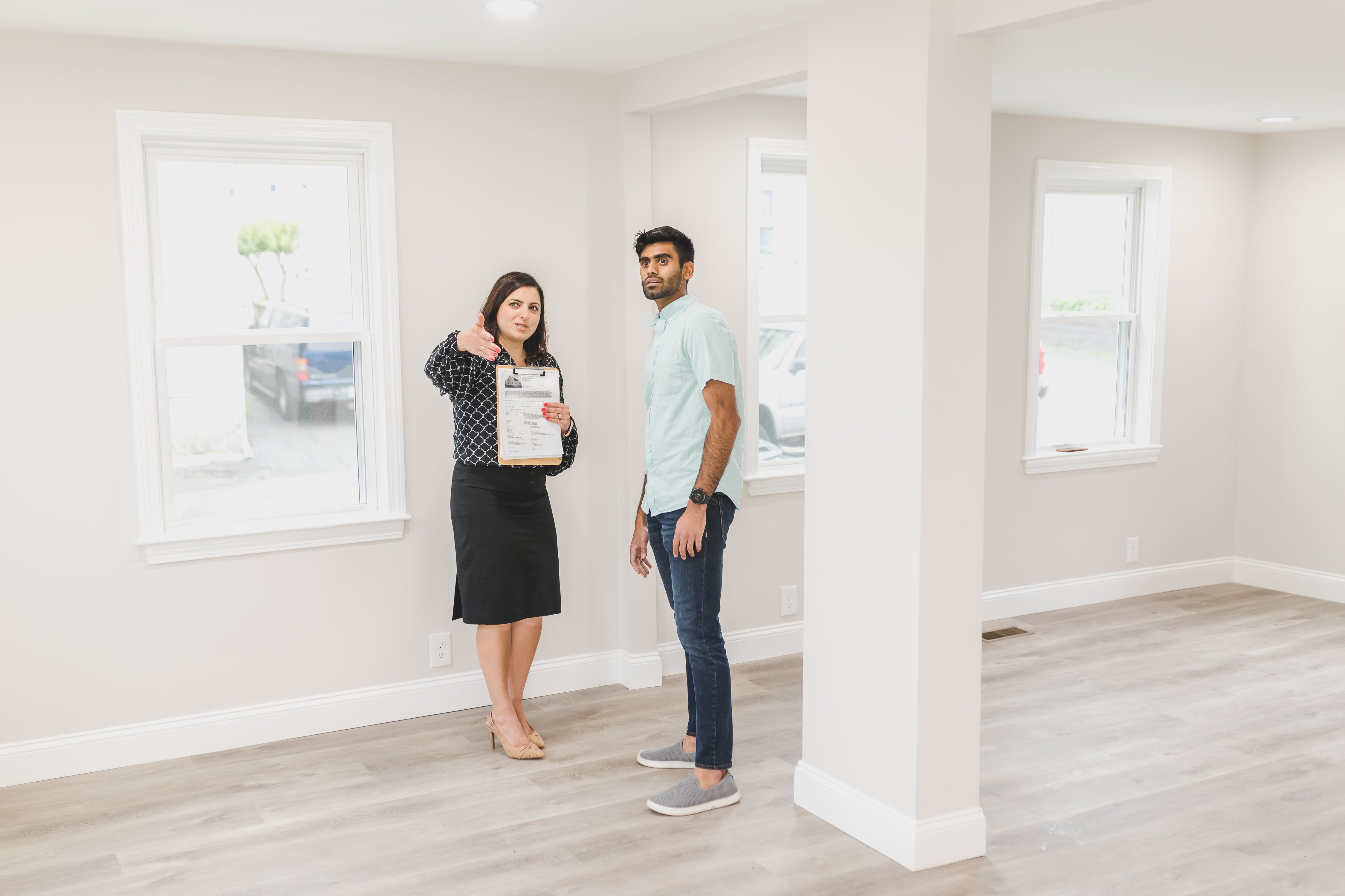 woman showing the inside of the house to a homebuyer