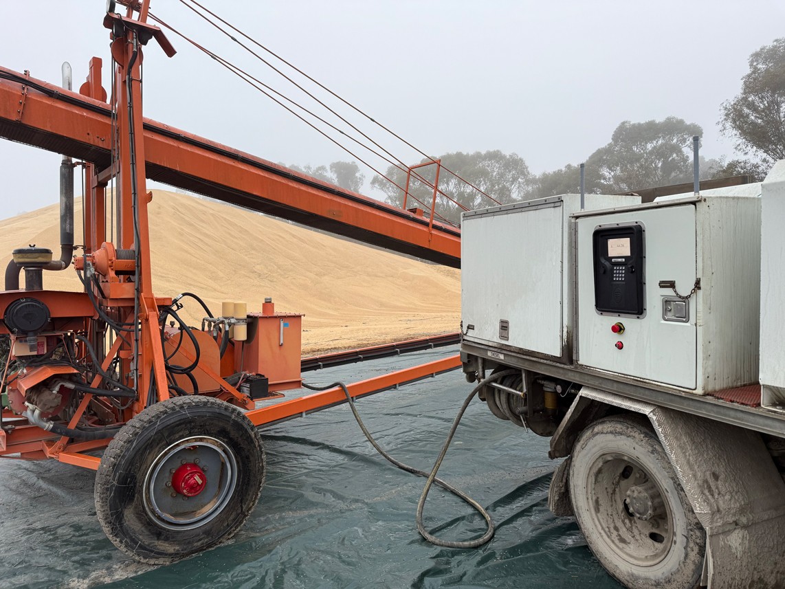mage of the SmartFill Gen 3 operating on a mining site with a truck in the background.