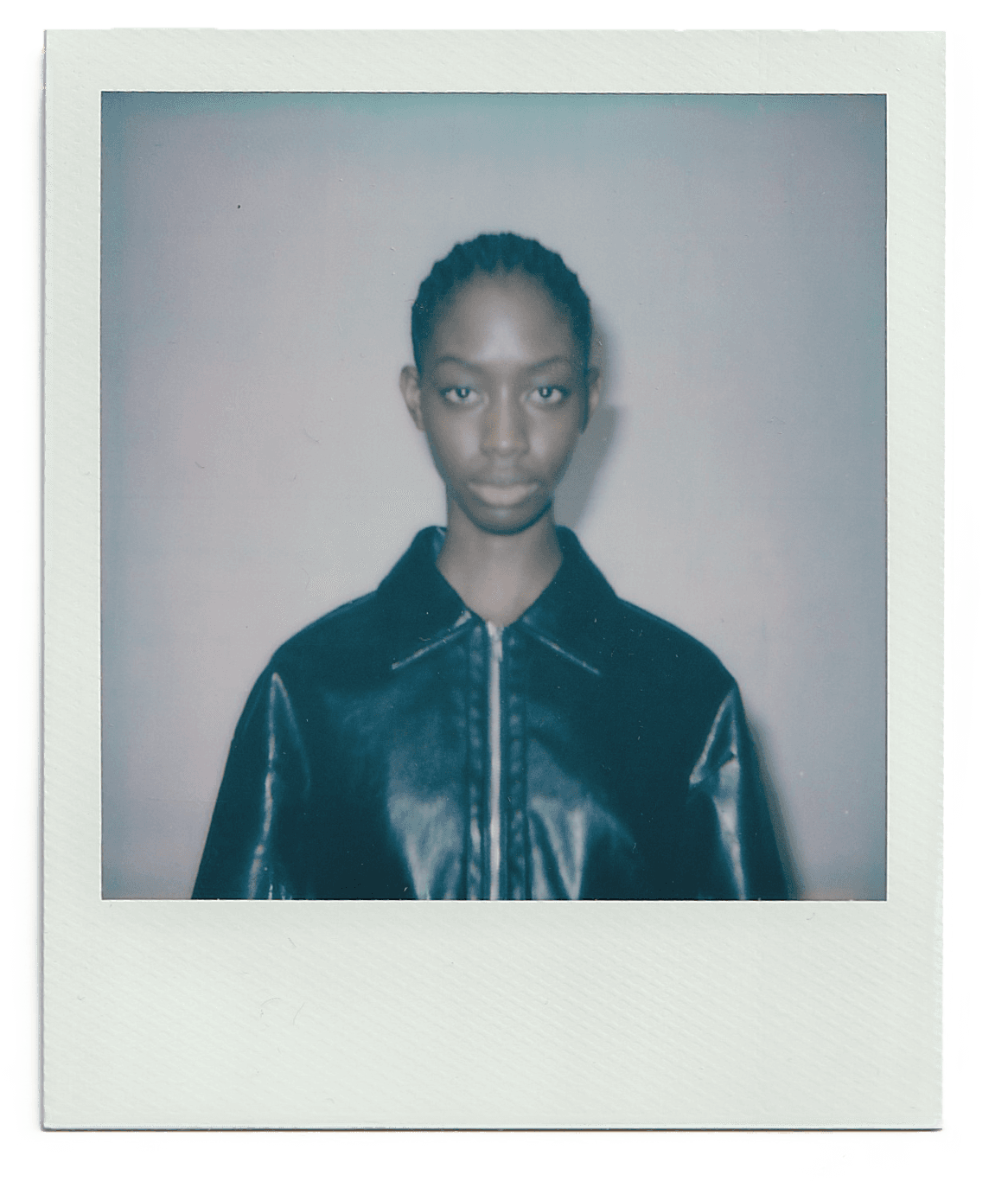 Young woman in casual clothing posing against a white background.