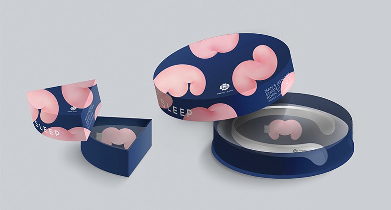 An image of a round blue box printed with pink Styrofoam like pieces which contains a pink usb drive and a white collar headphone. Also there is another box but with a fourth of a size as the original which contains only a pink usb drive.