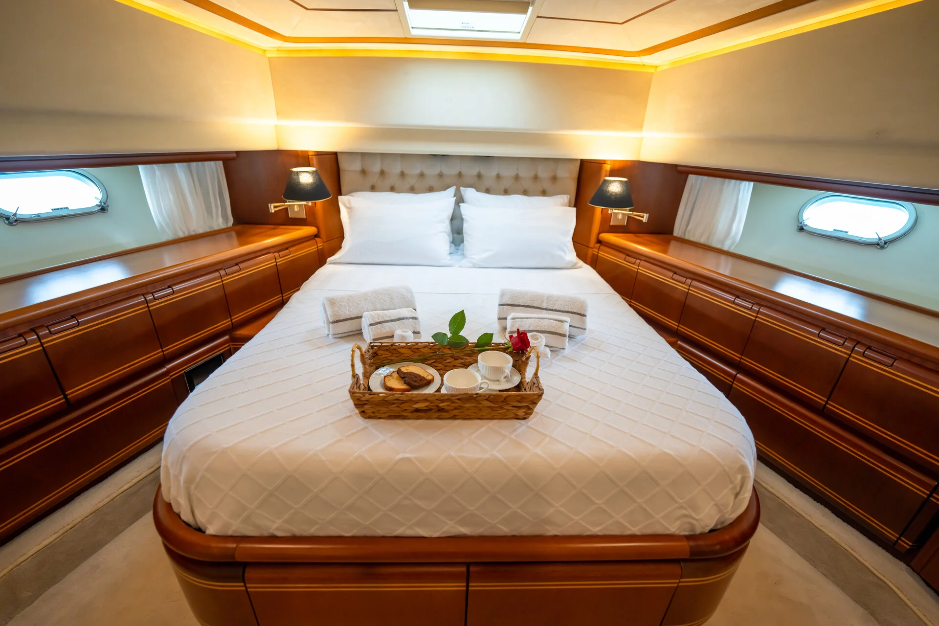 White Rock 36 speedboat with captain at helm cruising calm blue waters near Paros coastline with hills in background.