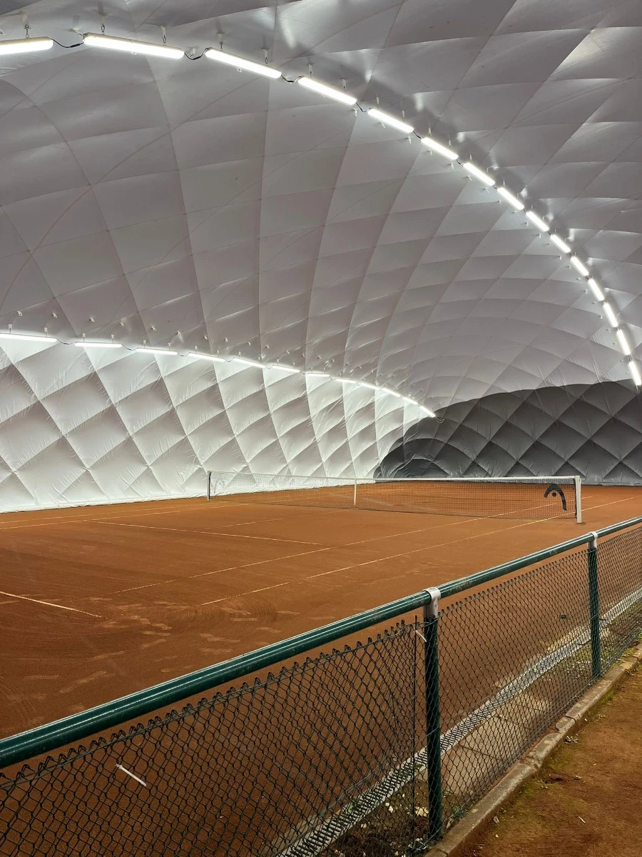 a man holding a tennis racquet on a tennis court