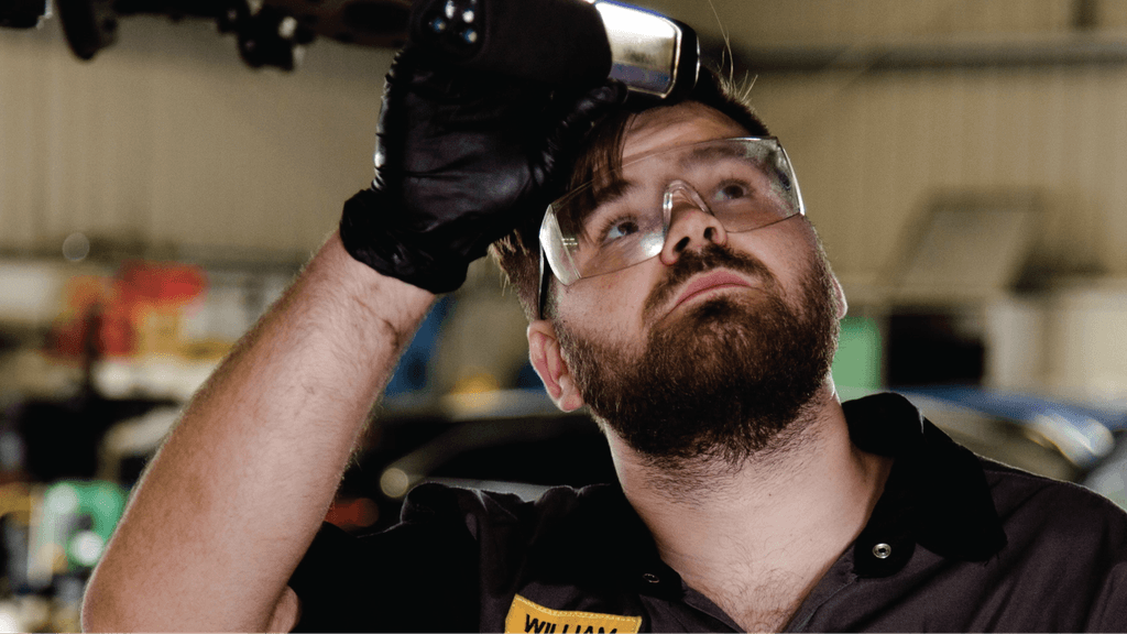 AA mechanic looking up at something he's repairing