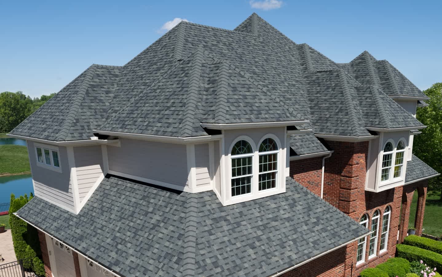 Beauty shot of a beautiful home with Owens Corning TruDefinition Duration shingles in Estate Gray color.