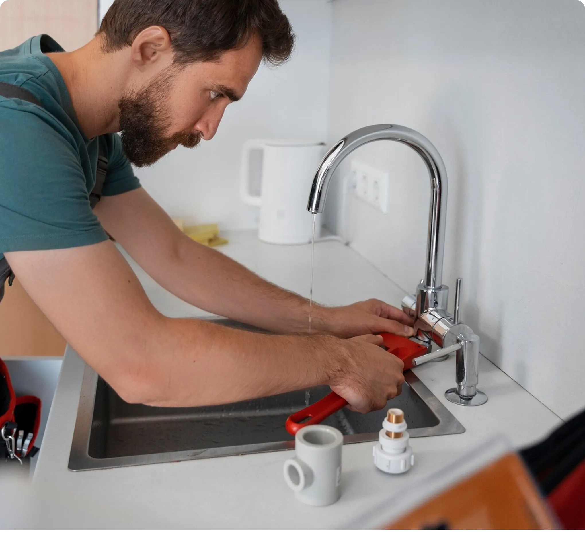 Pipewise technician working on a kitchen tap