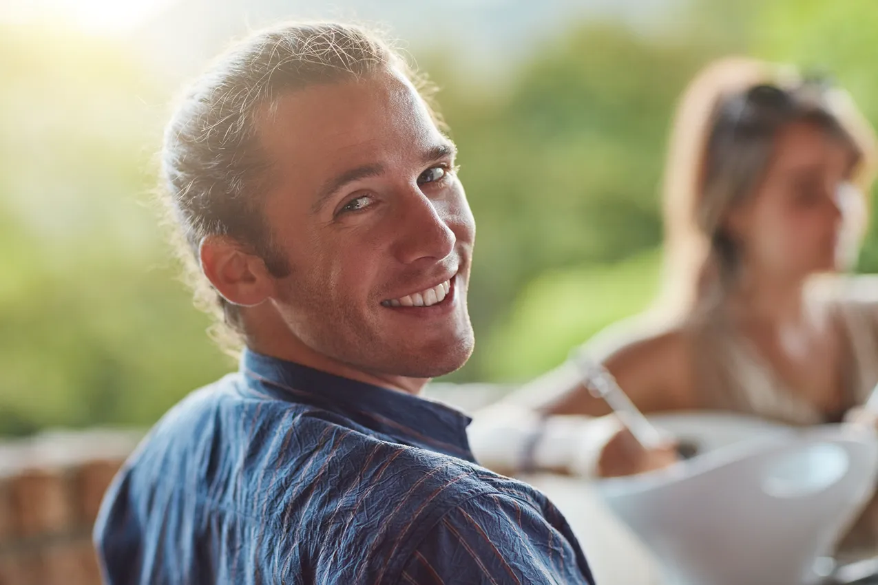 happy man looking over shoulder