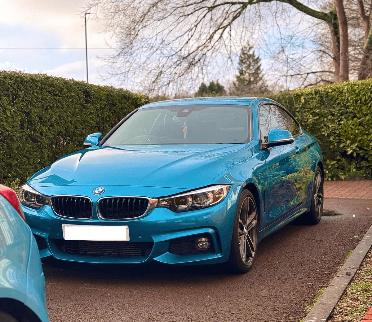 black bmw coupe on snow covered road during daytime