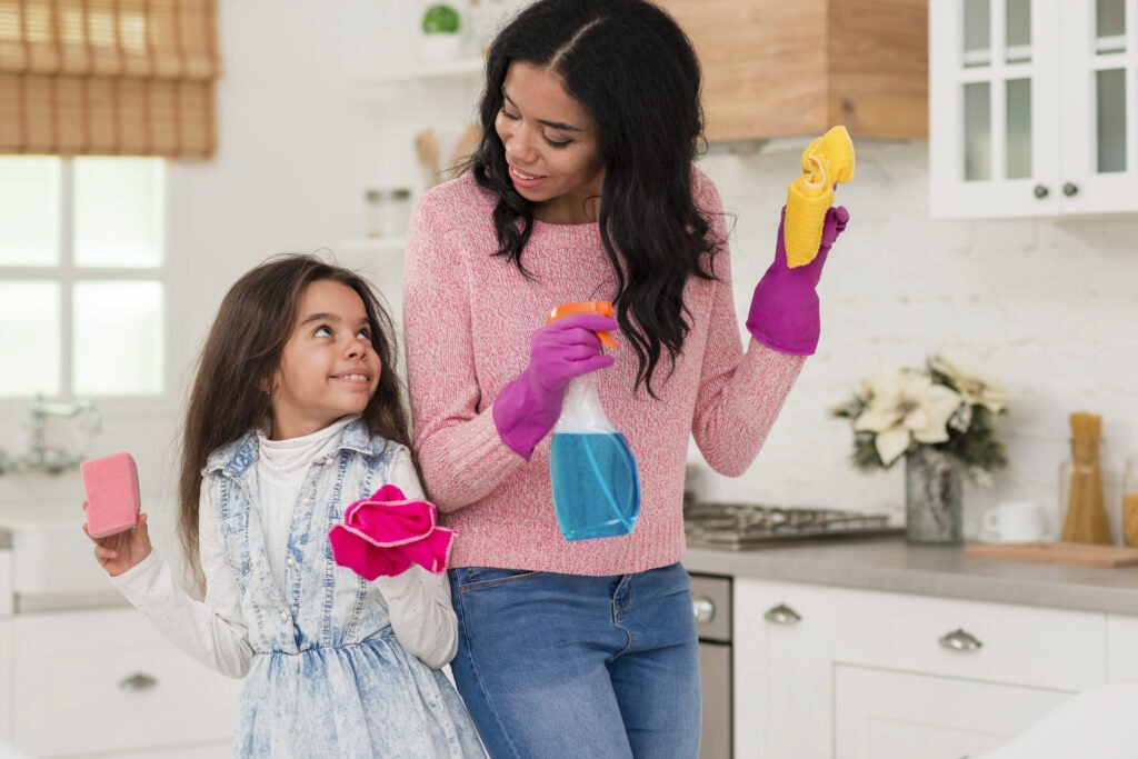 mom and daughter cleaning house