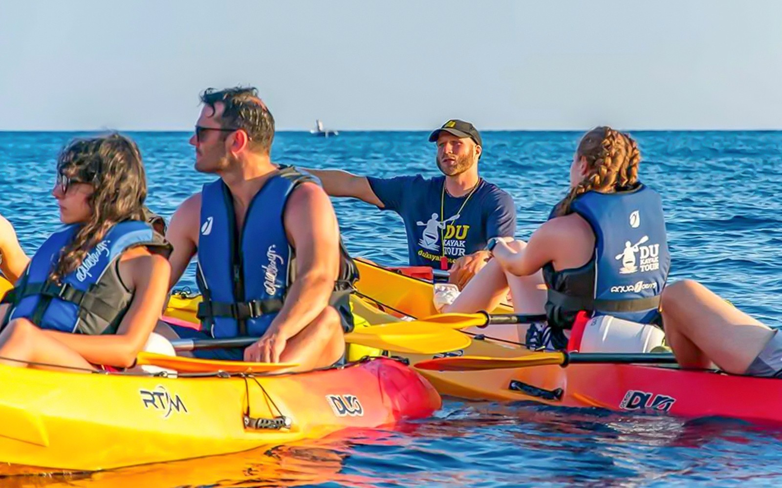Kayakers with a guide on a sunset tour in Dubrovnik.