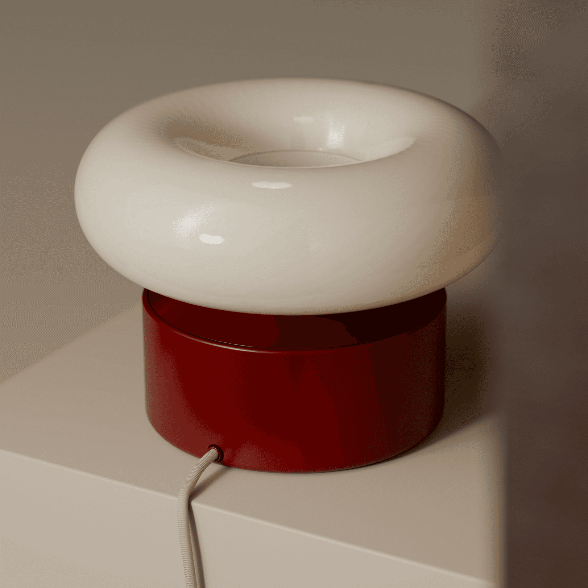 A burgundy nomadic lamp with a donut shaped lamp shade.
