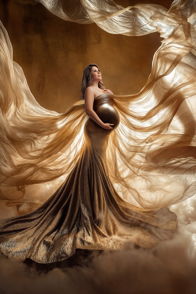 Expecting mom wearing elegant flowing maternity gown during studio photoshoot in Los Angeles.