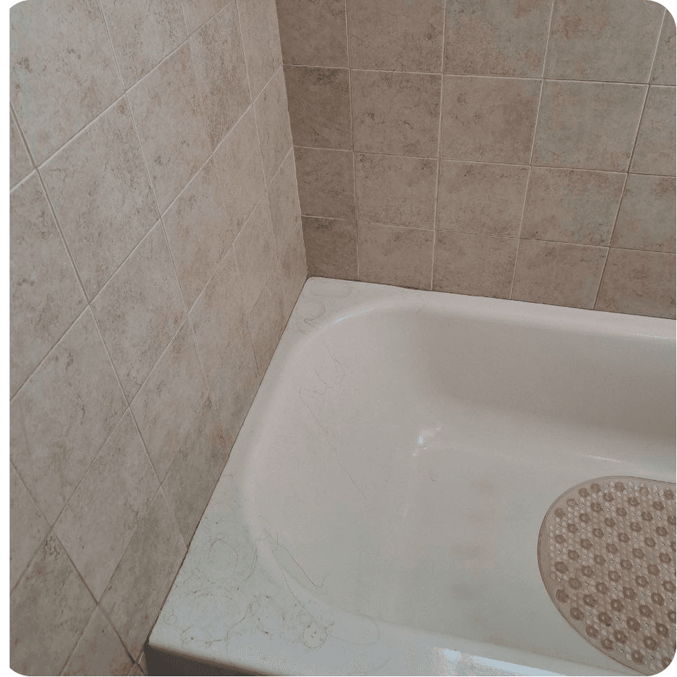 A photo of a dirt bath with hair and tile before cleaning.