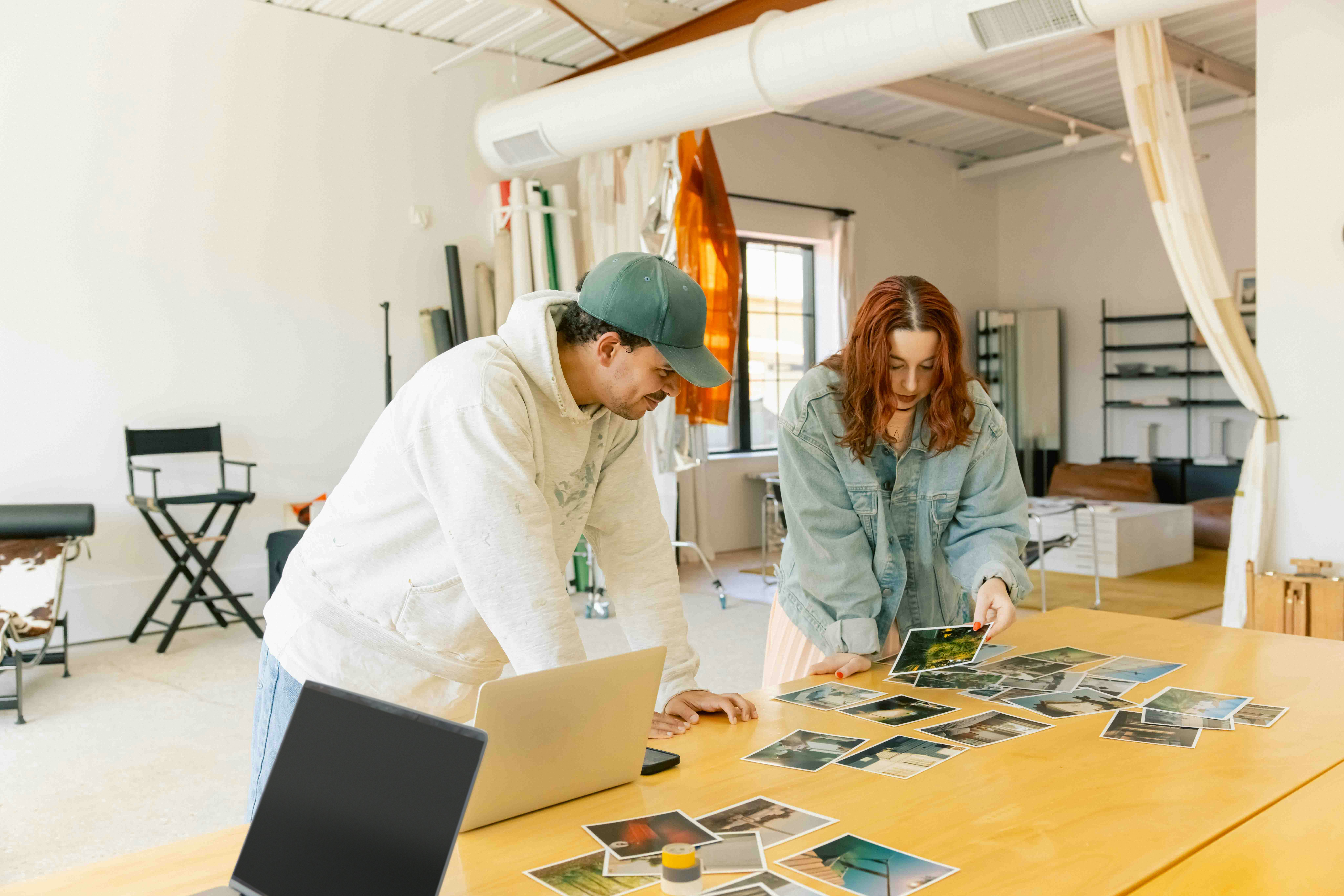 Film clapperboard in focus with glowing orange background, misty street, and silhouettes of people and lights; conveys mystery and anticipation.