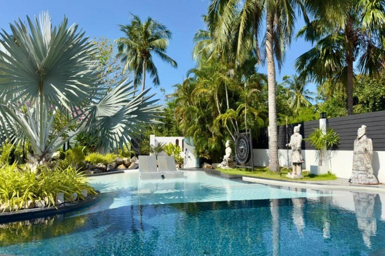sunloungers fronting buildings near mountain