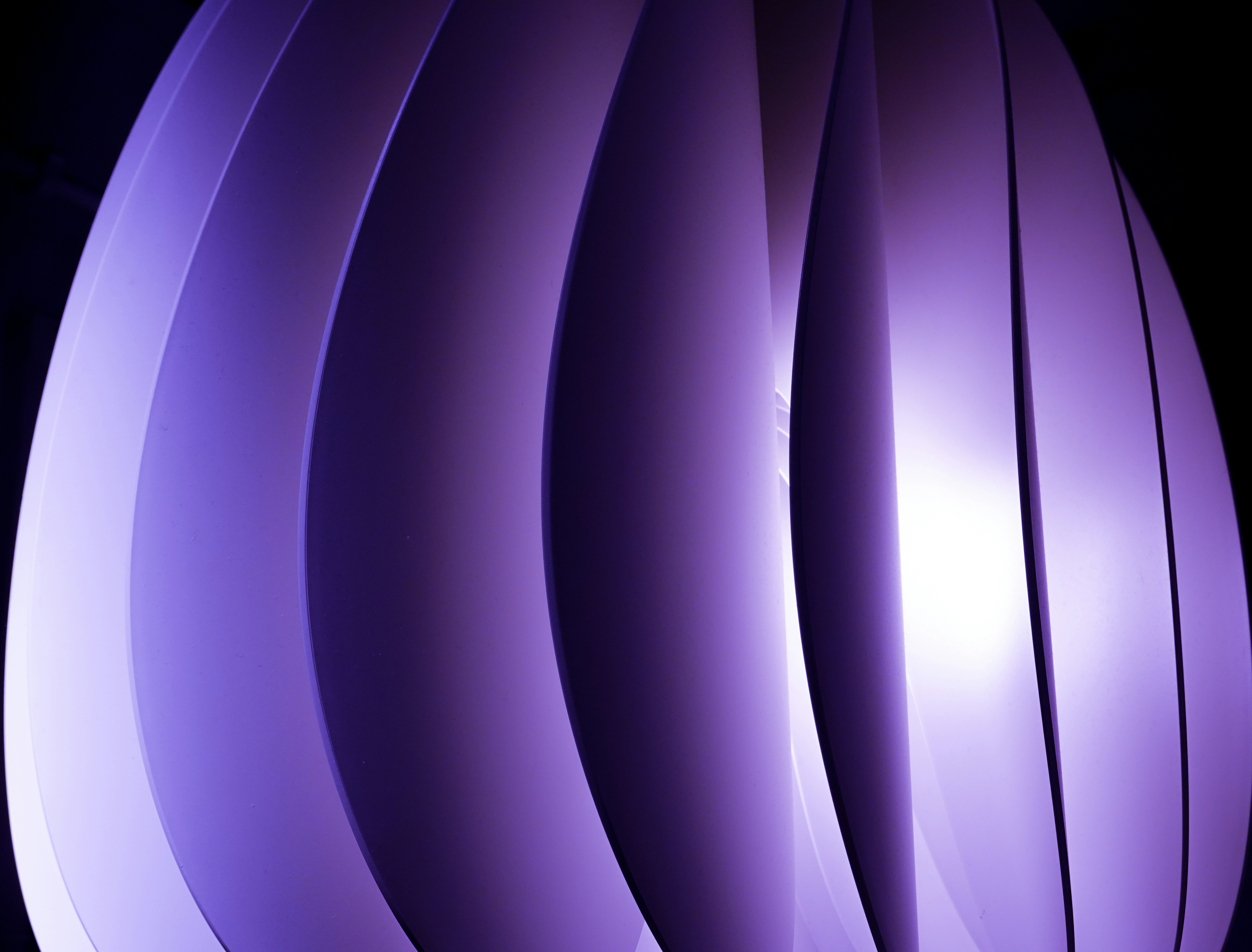 a close up of a purple object with a black background