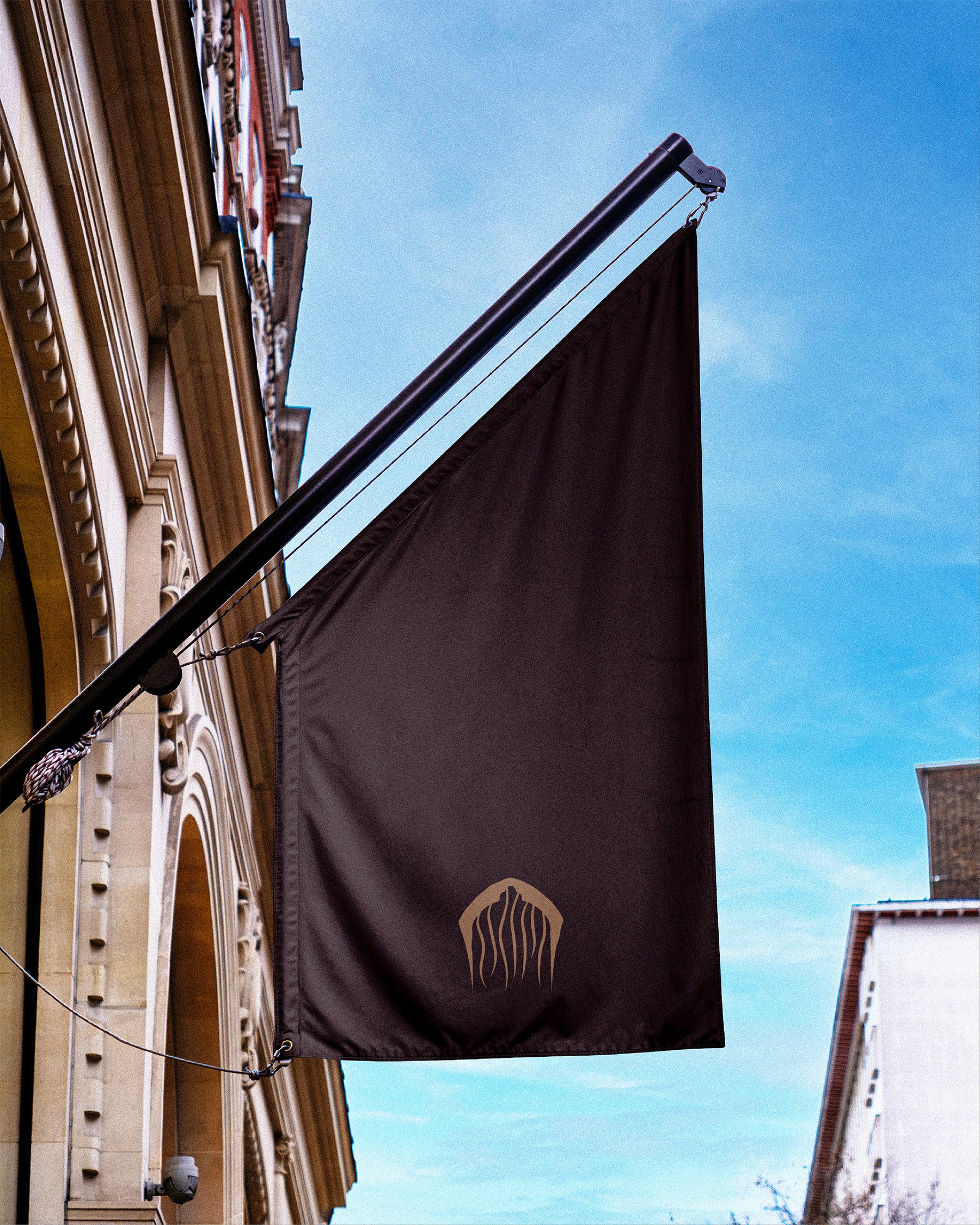 Bongo flag mounted on building facade with beige symbol