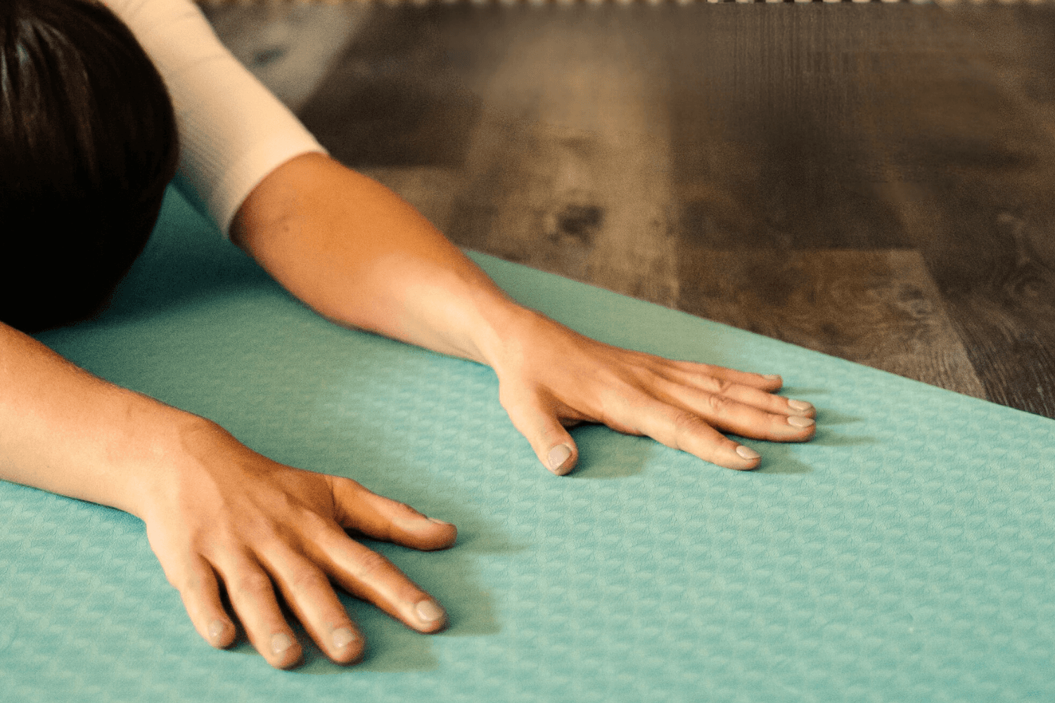 Person stretching on a yoga mat with glowing skin, reflecting a holistic approach to beauty and self-care