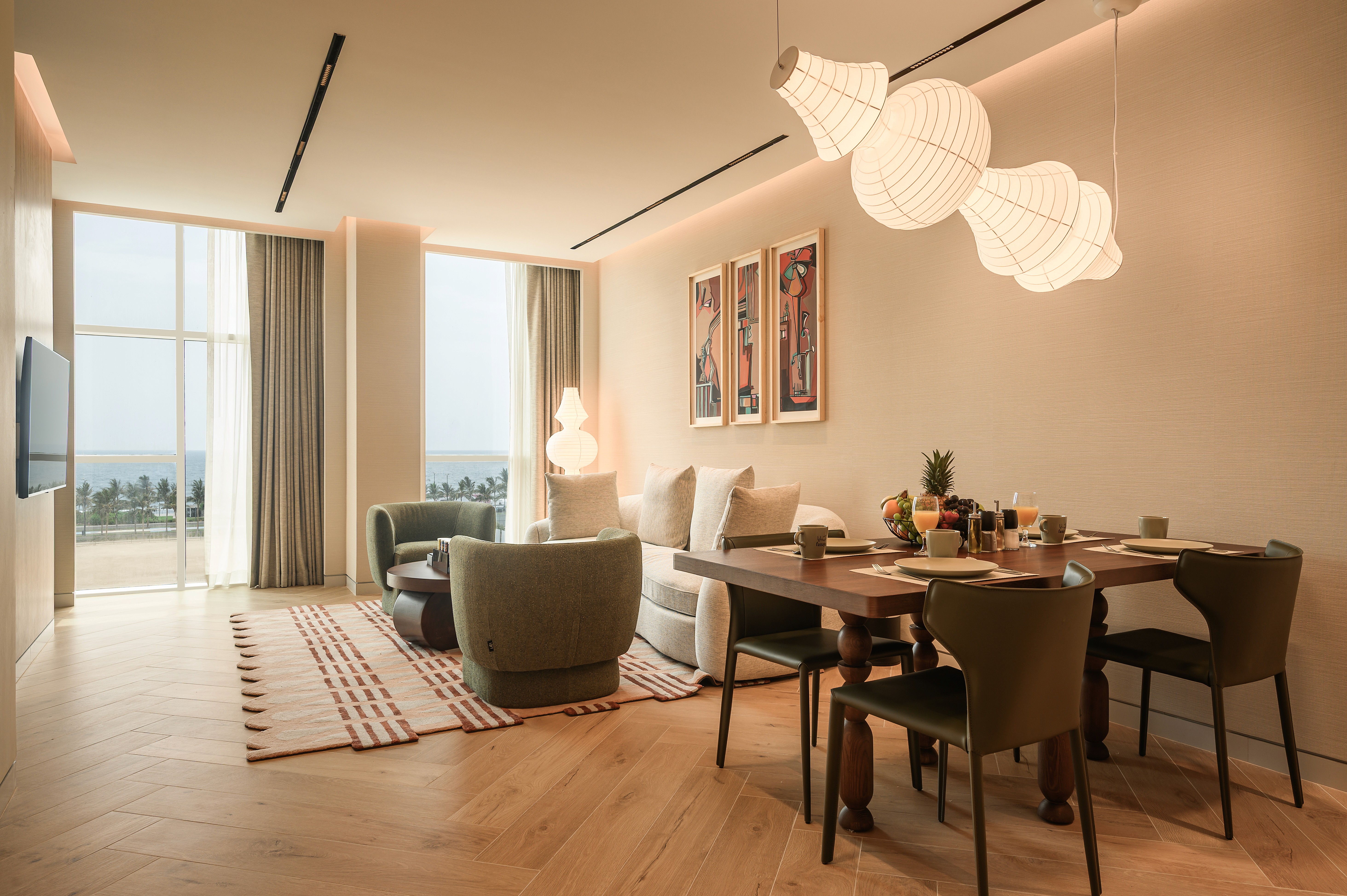 nfinity pool blending into the ocean view, minimalist sun loungers in soft neutral fabric, curved architecture