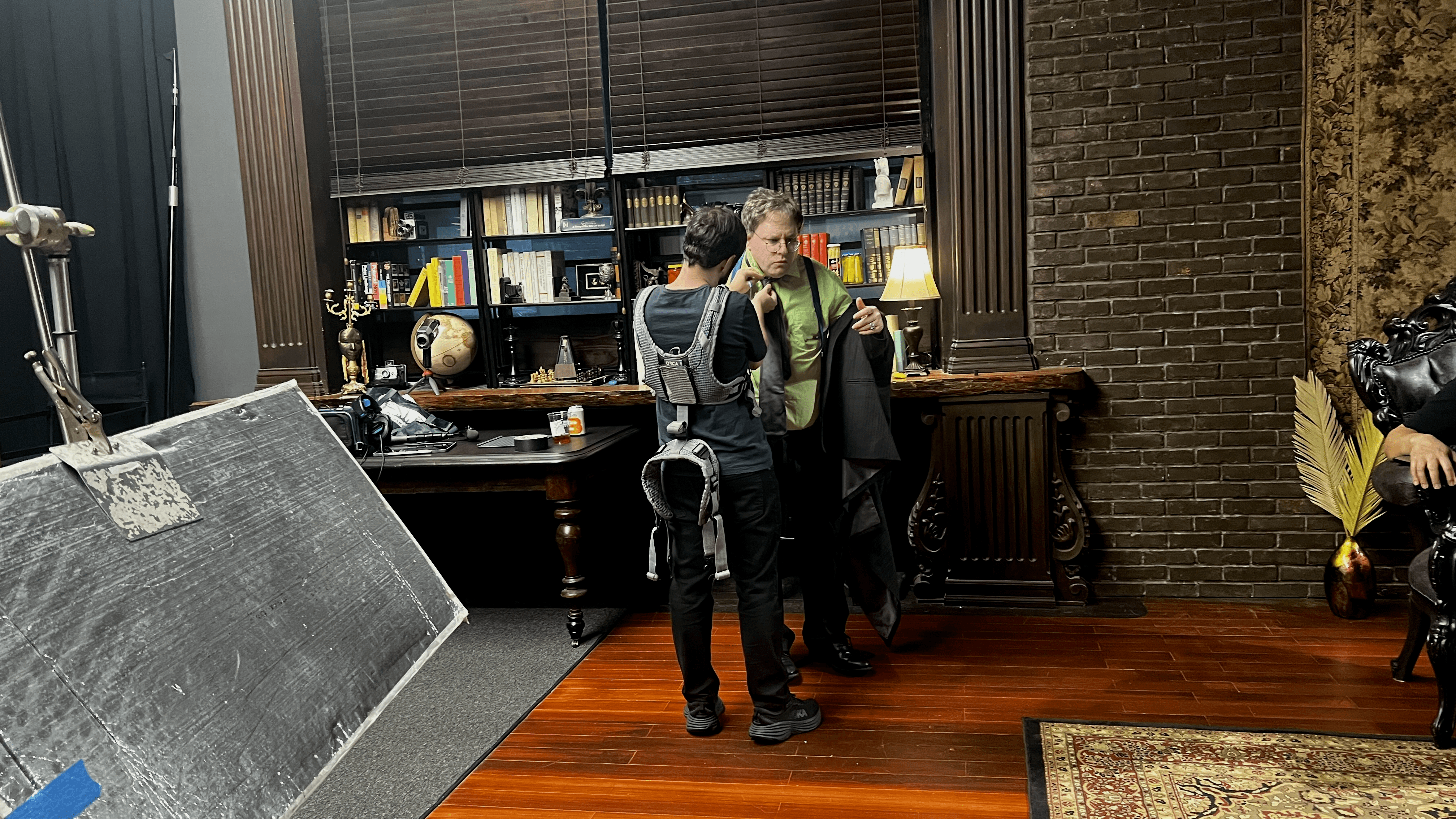 Crew getting the host ready between takes on the set