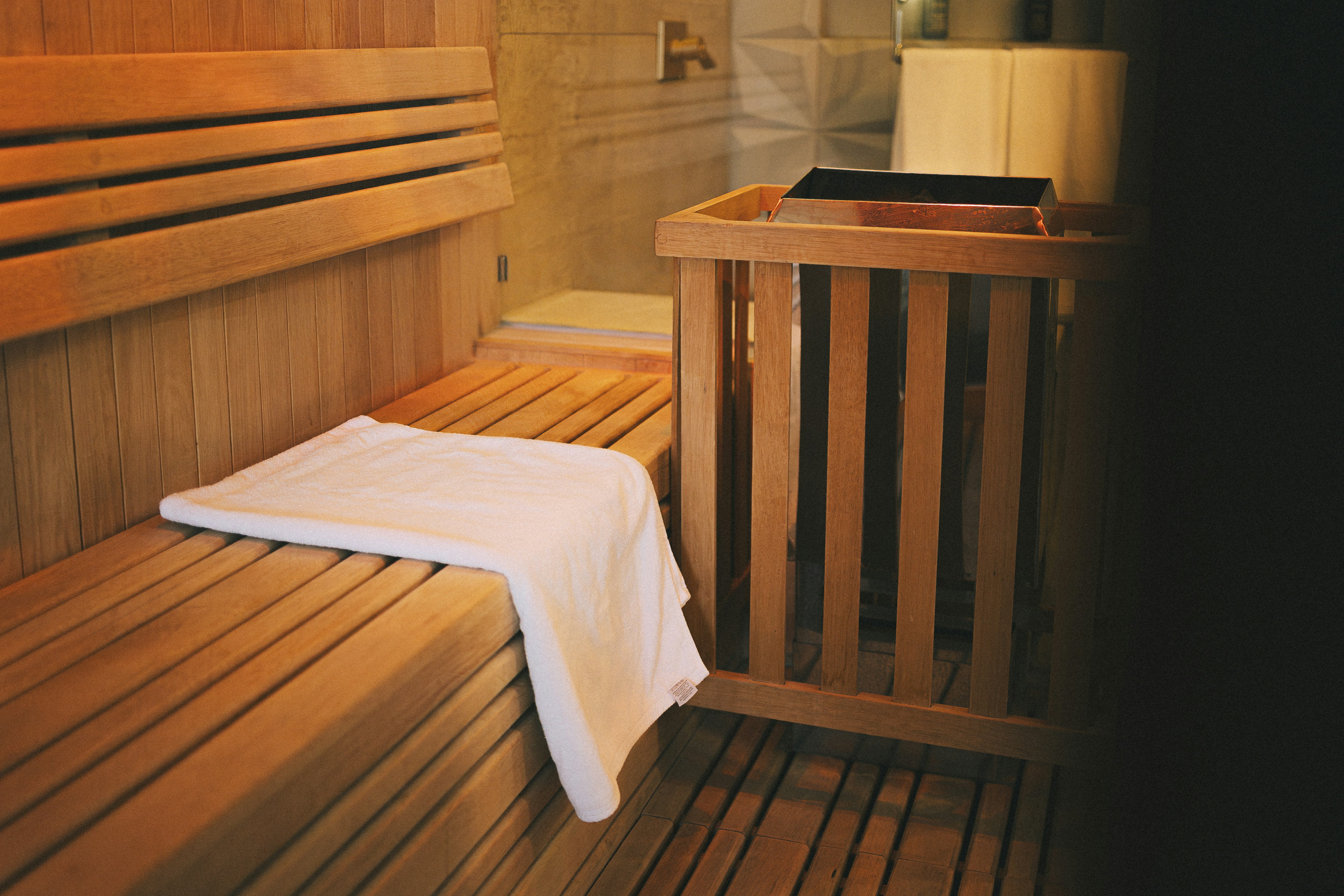 Fresh white towel laid on a sauna bench.