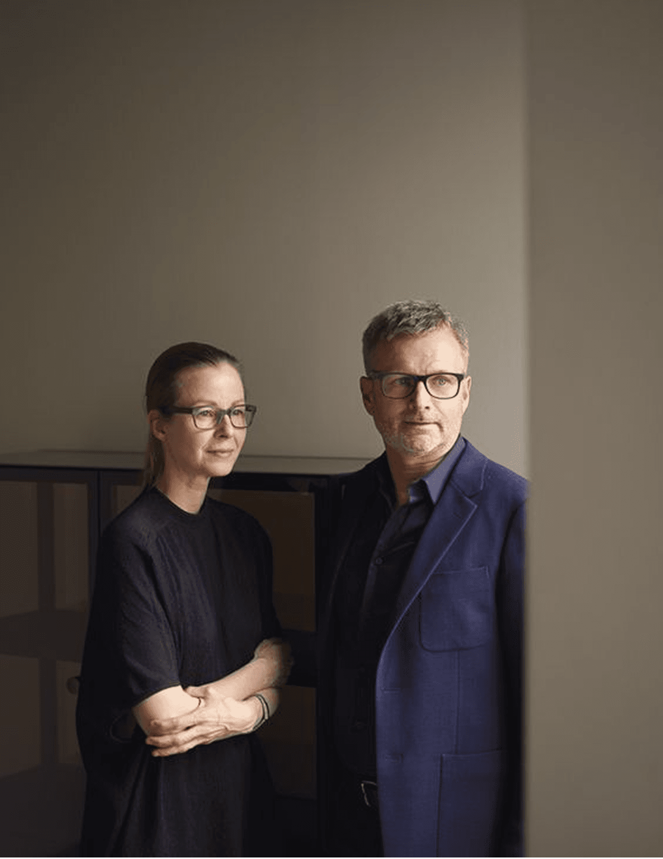 Four friends climbing over a wooden fence outdoors