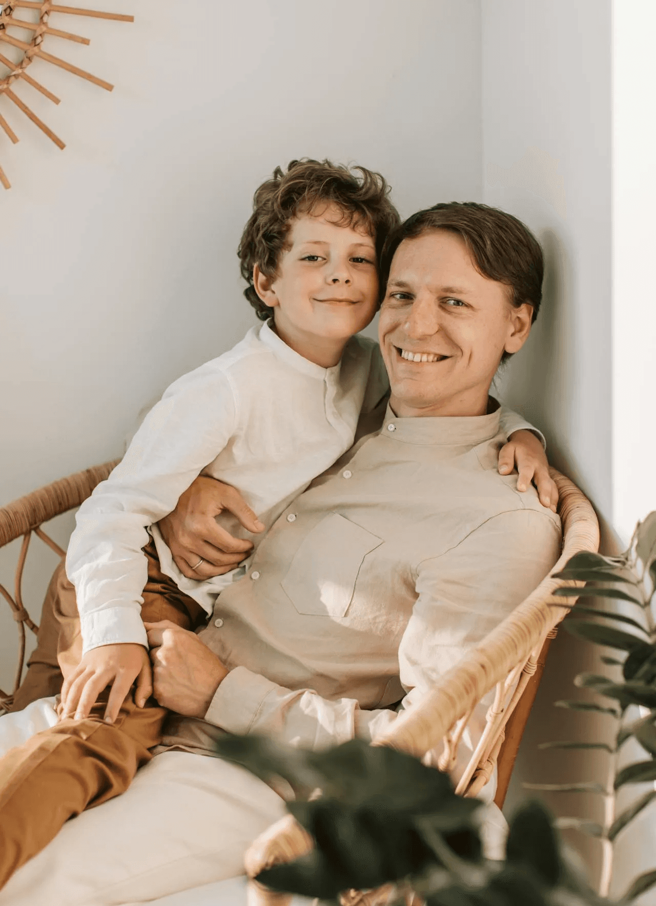 Confident man with short brown hair and beard, wearing a navy zip-up in natural light