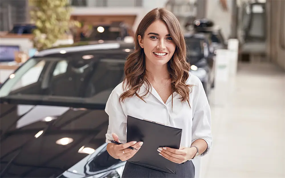 Auto body shop representative holding a tablet in a collision repair facility