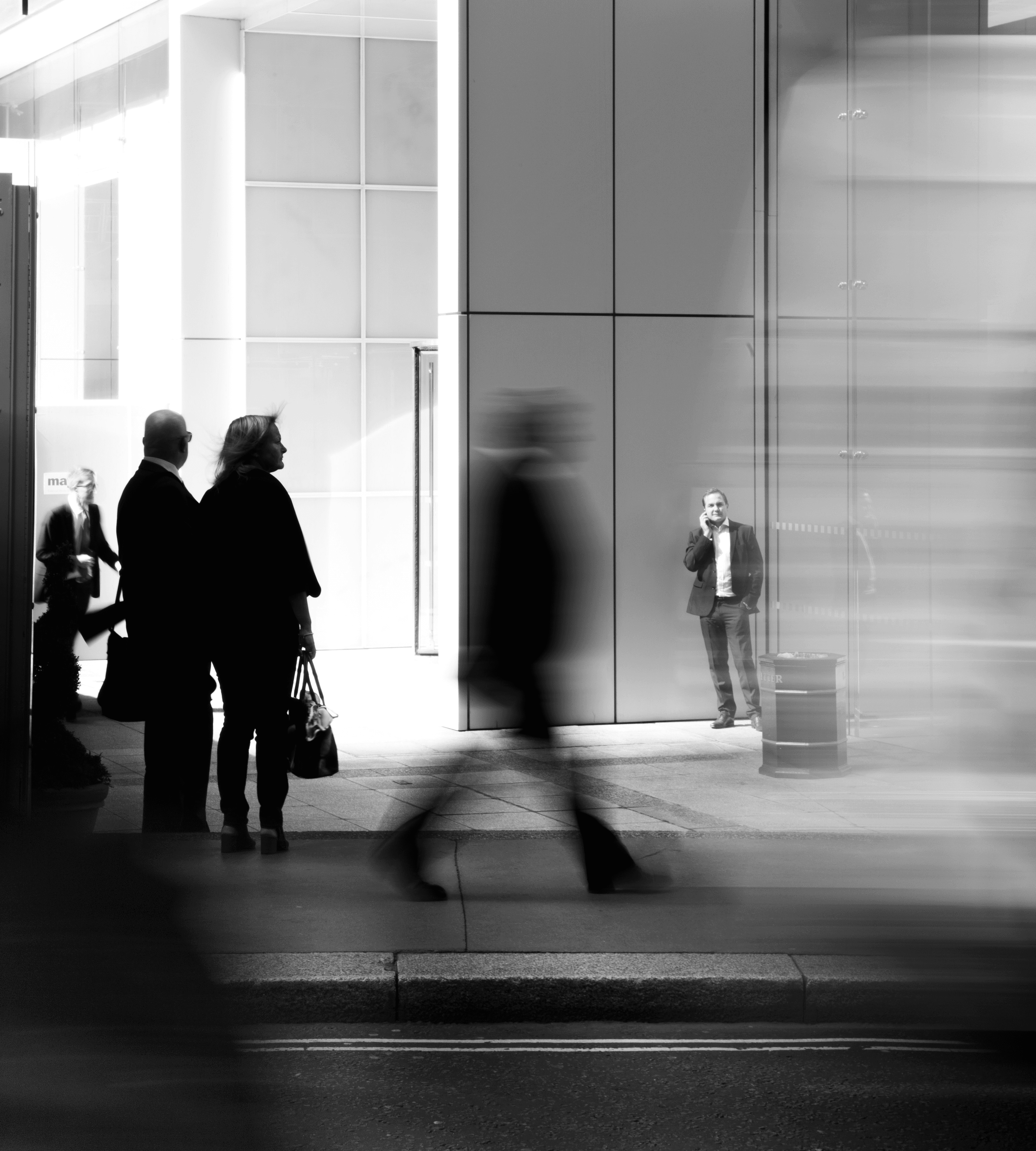 grayscale photo of people walking towards building