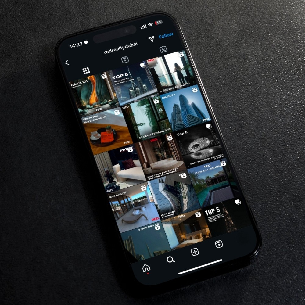 Black-and-white party photo of a smiling man in a check blazer among a crowd.