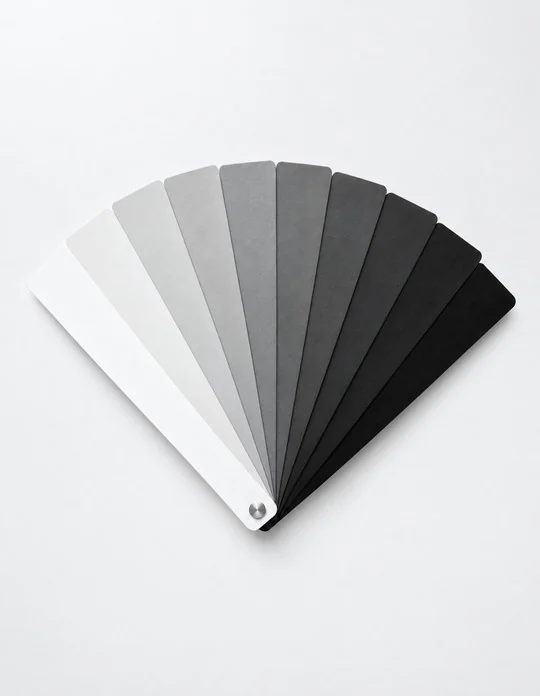 A fan of colour swatches running from white through grey to black.