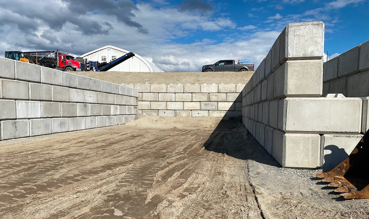 Completed mechanically stabilized lock block retaining walls forming storage area at Salish Soils