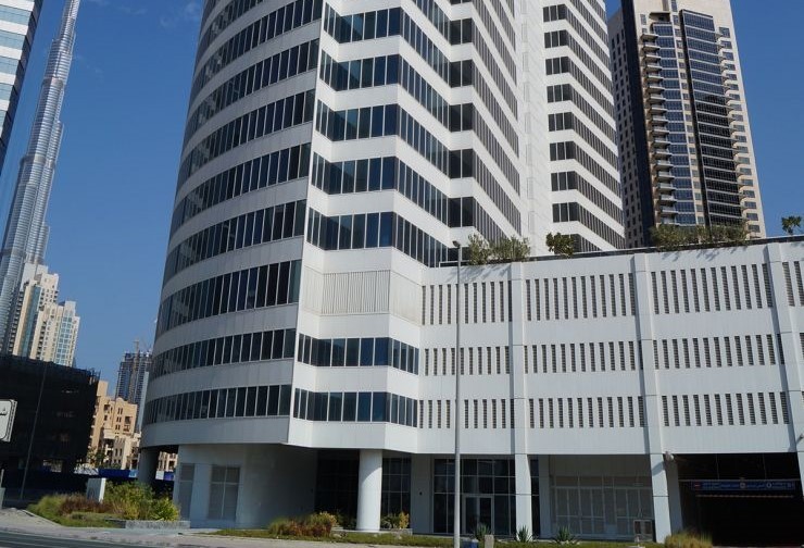 High-angle shot of a sleek commercial skyscraper offering premium office listings in a central business district.