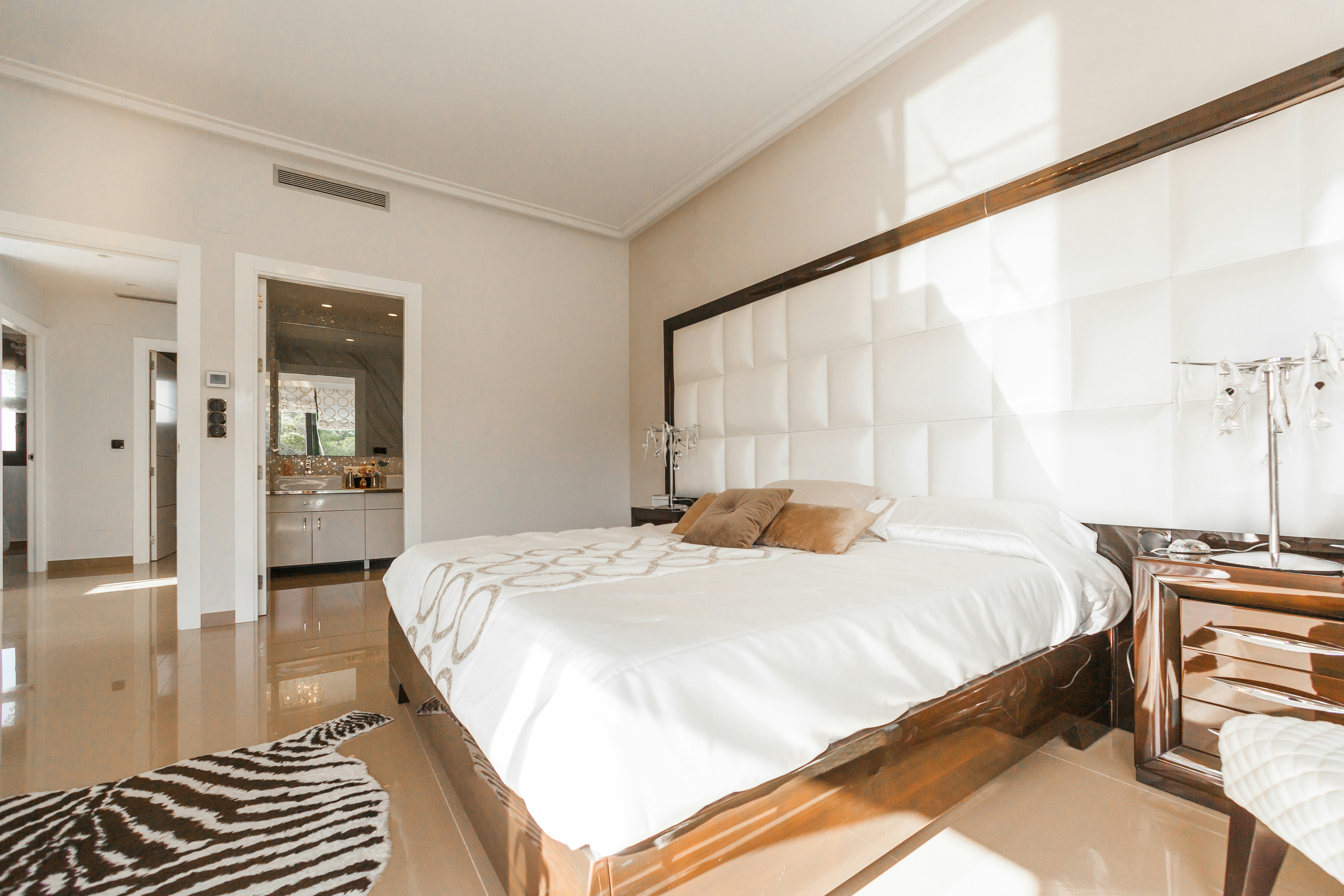 Spacious bedroom with a king-size bed and modern decor.