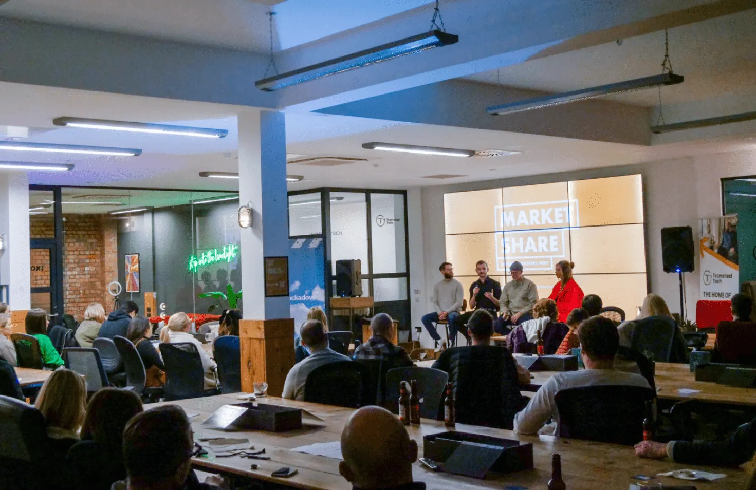 People watching a presentation in an indoor setting.