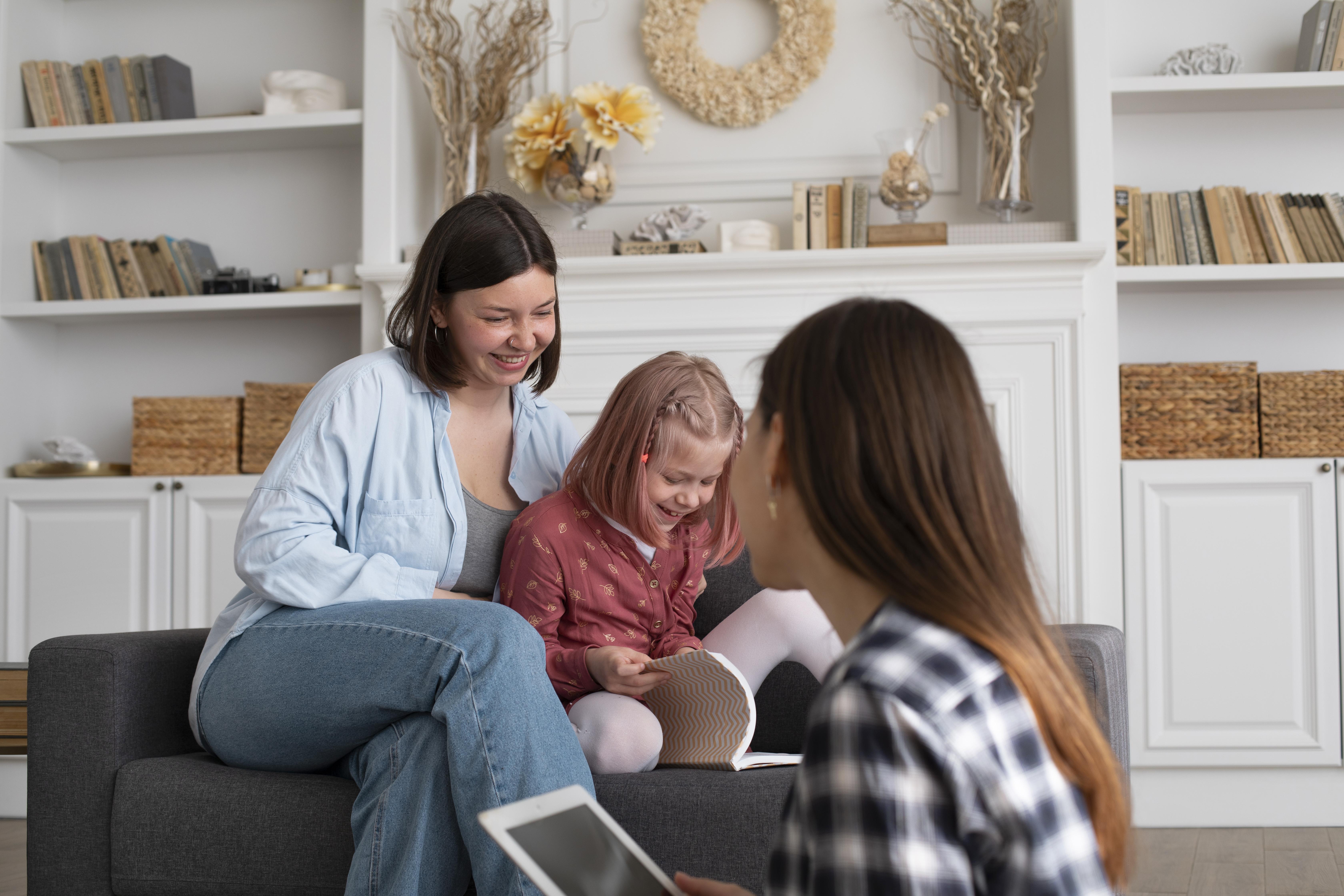 Conversion Truth for Families - Mother of a toddler sitting on the couch togerher, with a teenage sibling on the computer watching them