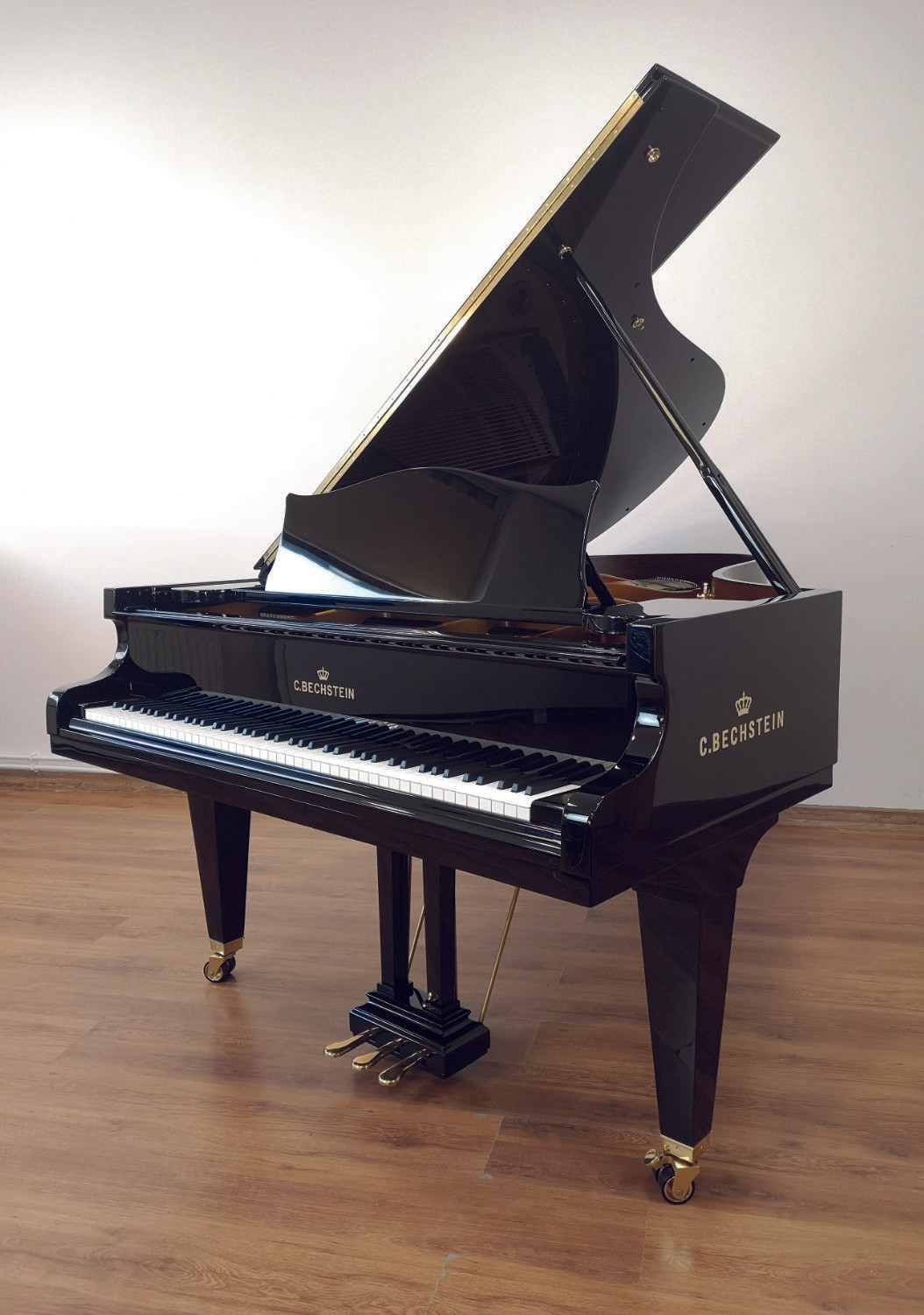 A full view of the C Bechstein piano highlighting its sleek black finish and modern elegance.