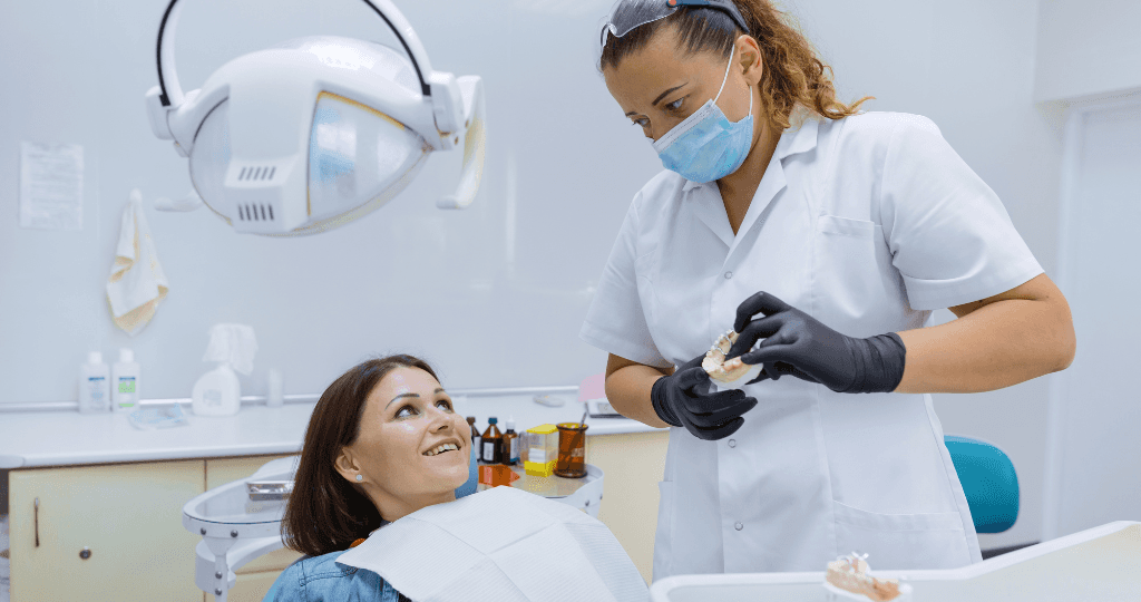 Dentist explaining dental prosthetics to a patient, emphasizing simplified financial solutions for clinics.