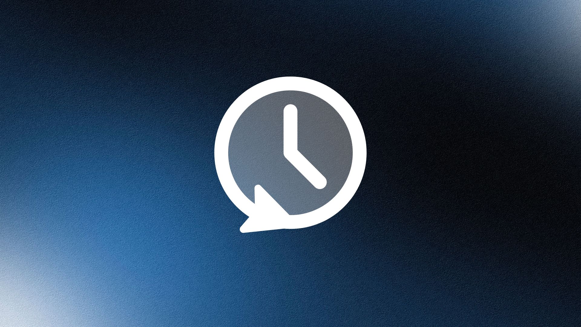 Smiling woman wearing a beige blazer and grey shirt, holding a folder while standing by a sunlit wall.