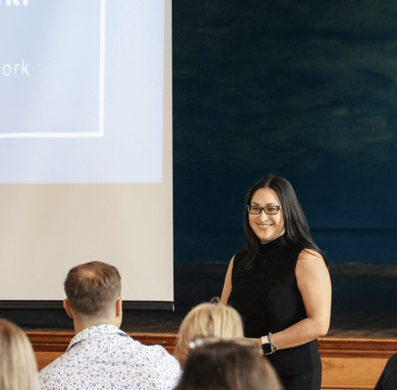 A photo of Dayna presenting and gesturing