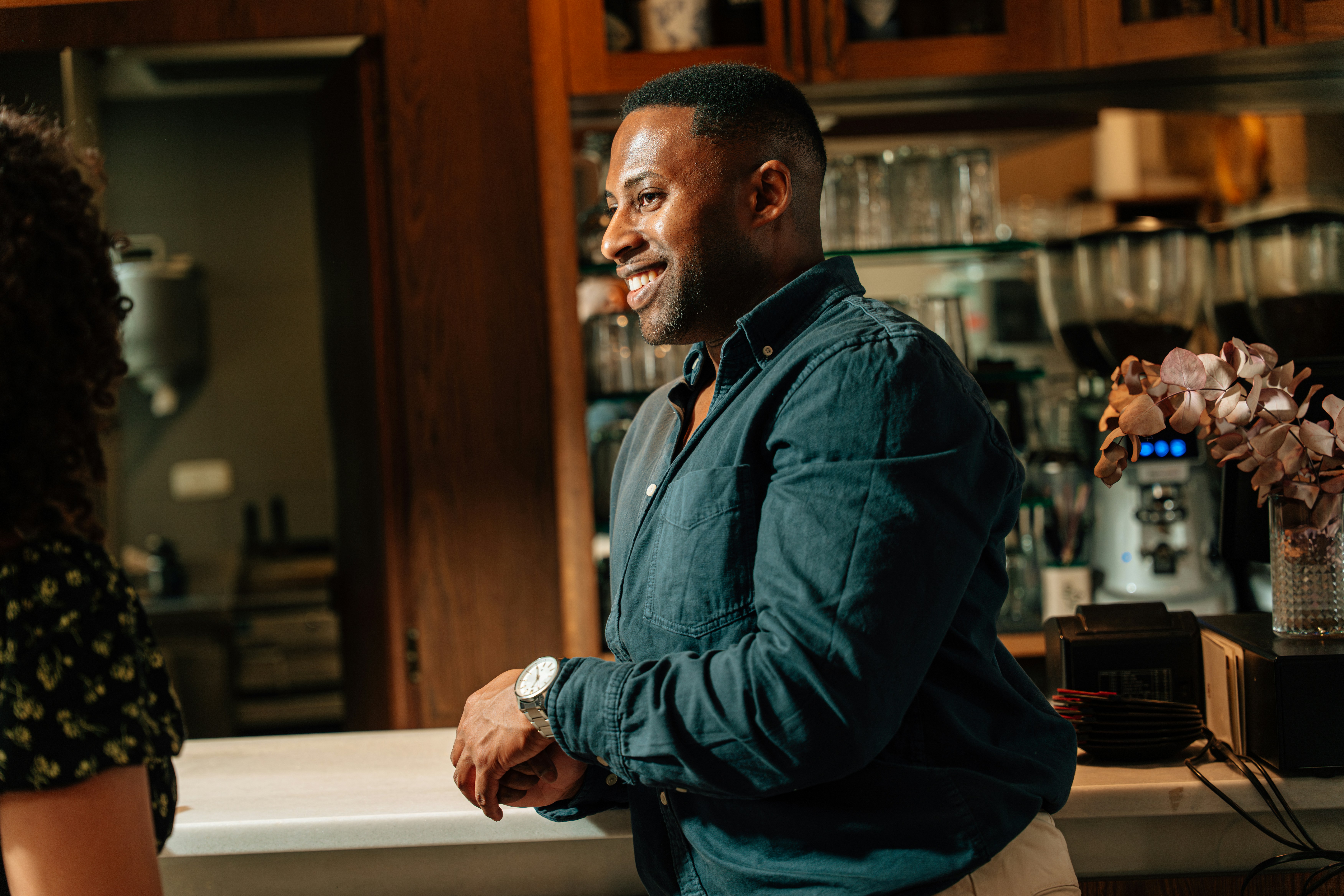 woman sitting around table holding tablet