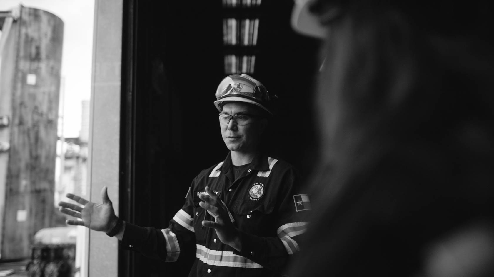 A man runs through a sunlit hallway with striped shadows.