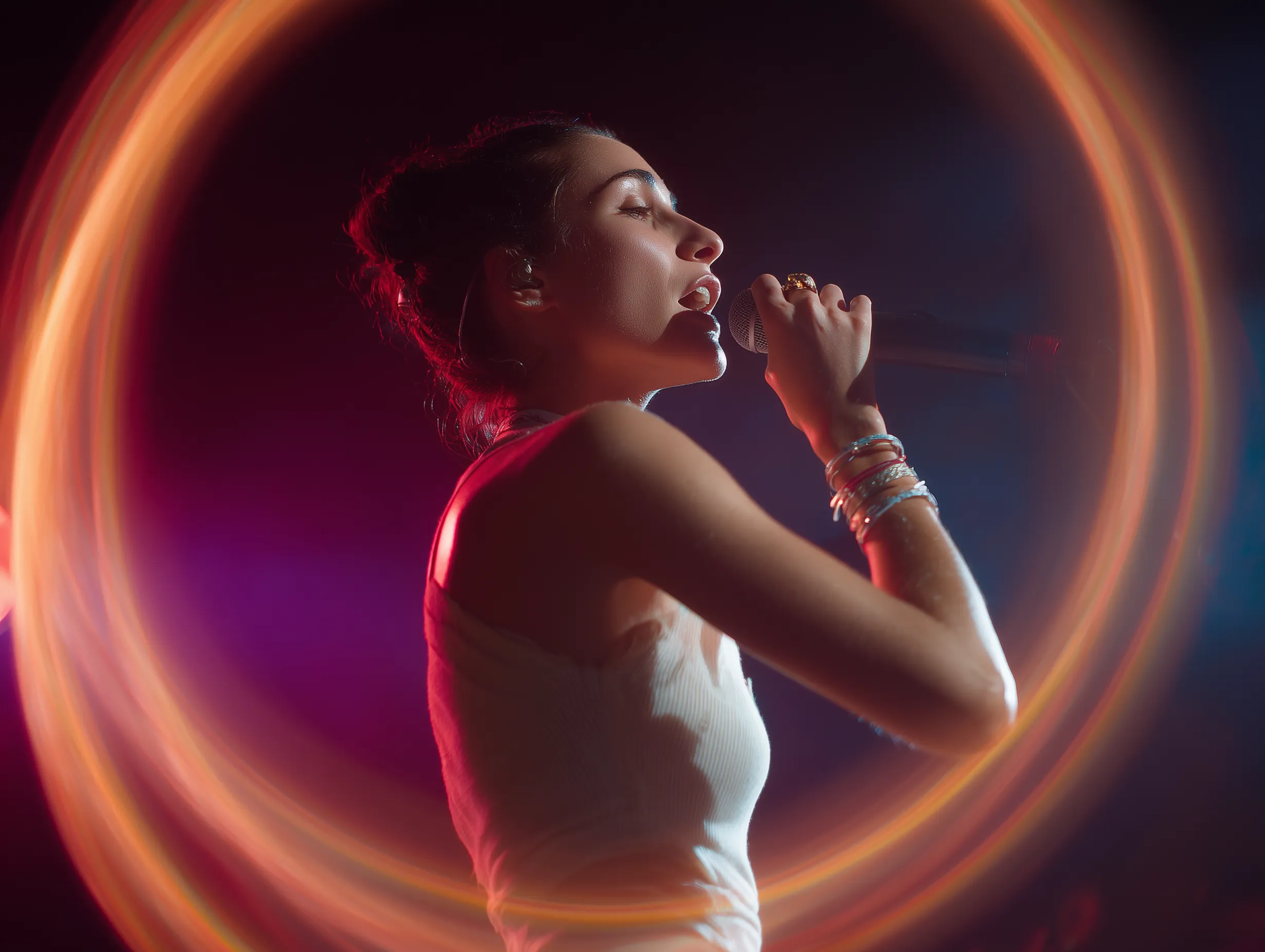Vocalist singing inside an orange light ring effect