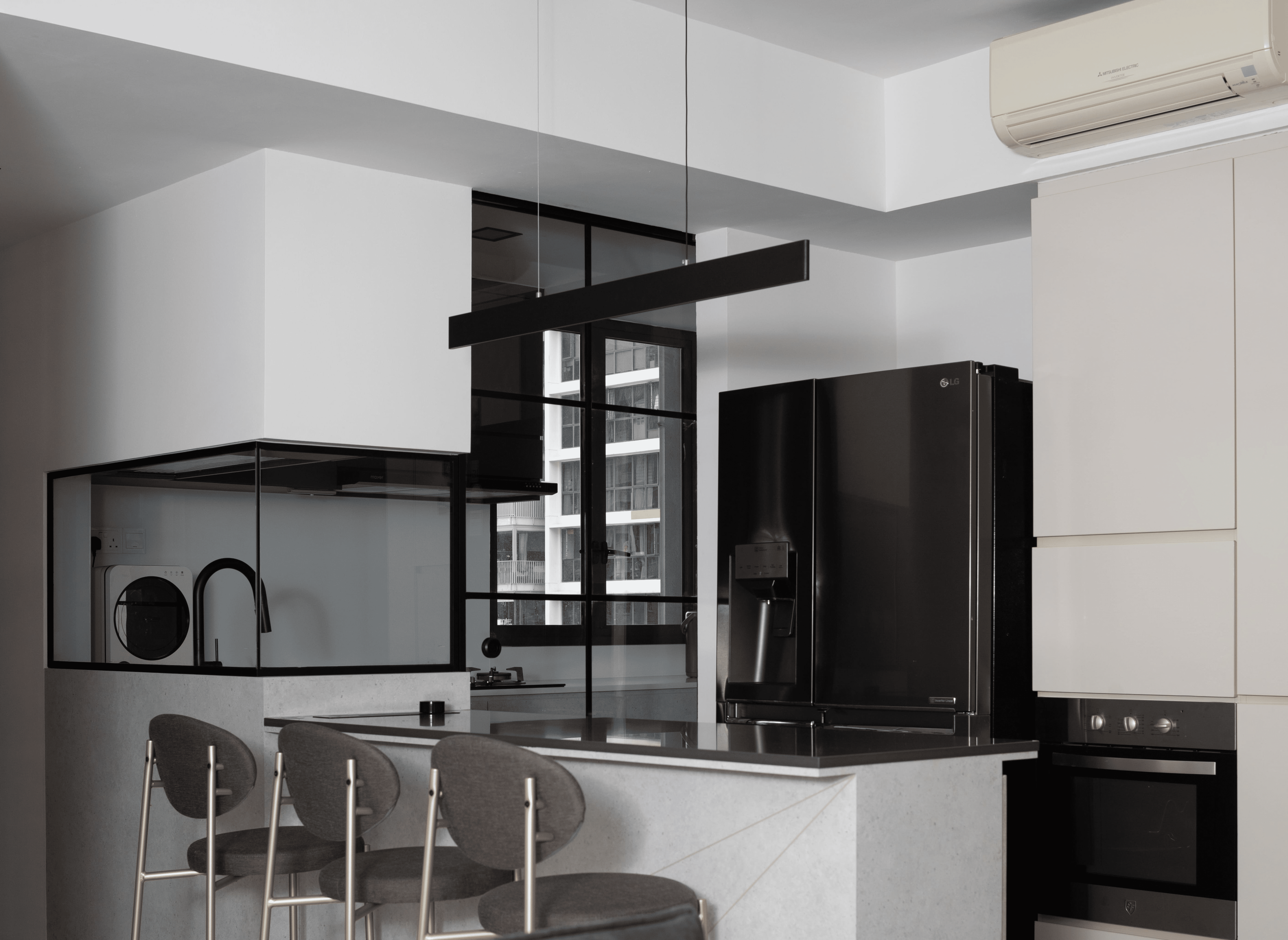 Galley kitchen with under-cabinet lighting, neutral palette, and compact appliances.