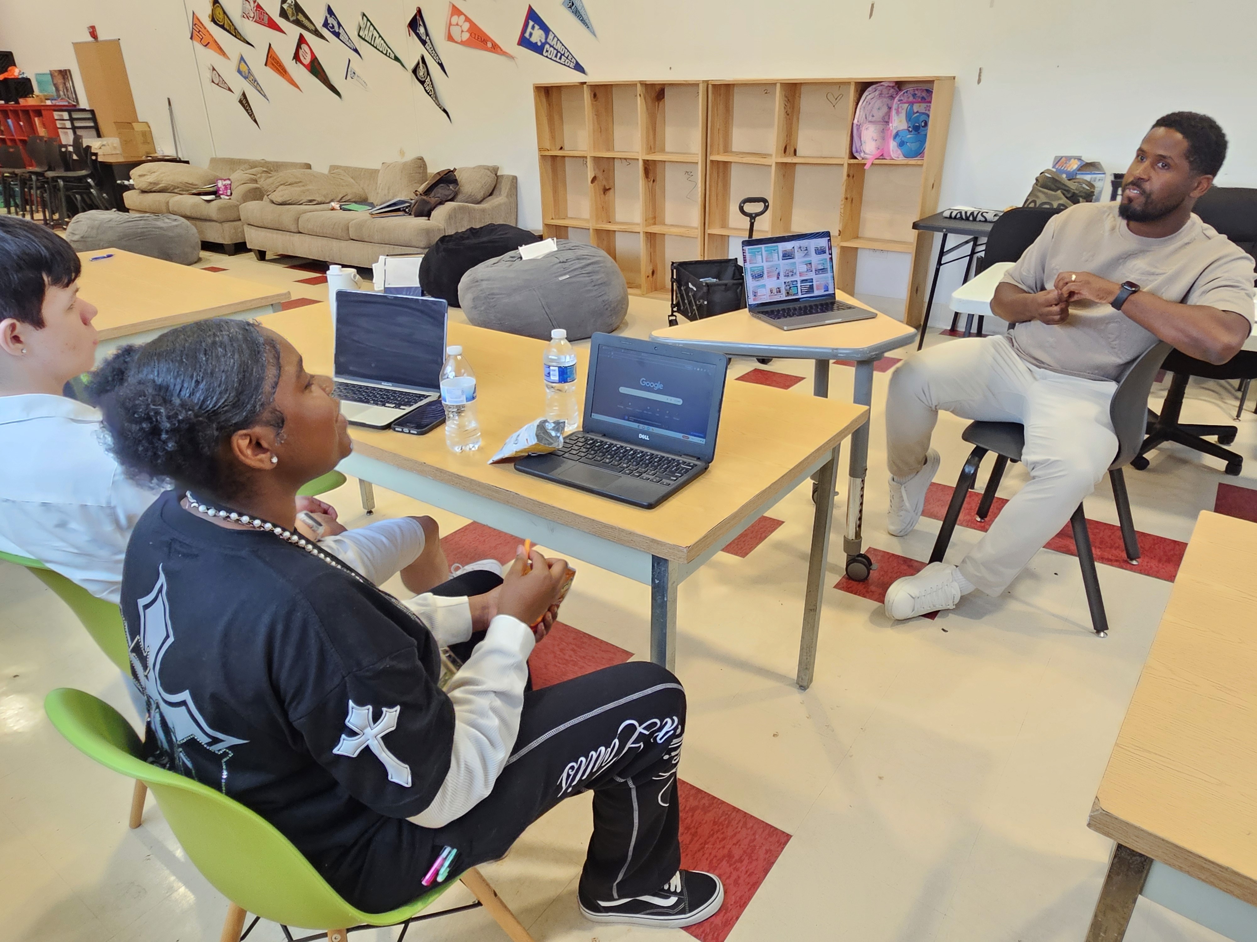 Trey Hester discusses graphic design with KIPP students during a JAWS workshop.