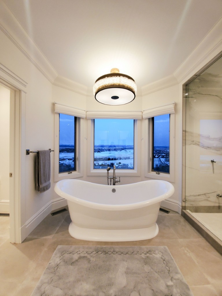 Image of Luxurious primary ensuite bathroom with freestanding tub and spa-like shower by KHD Homes design-build.