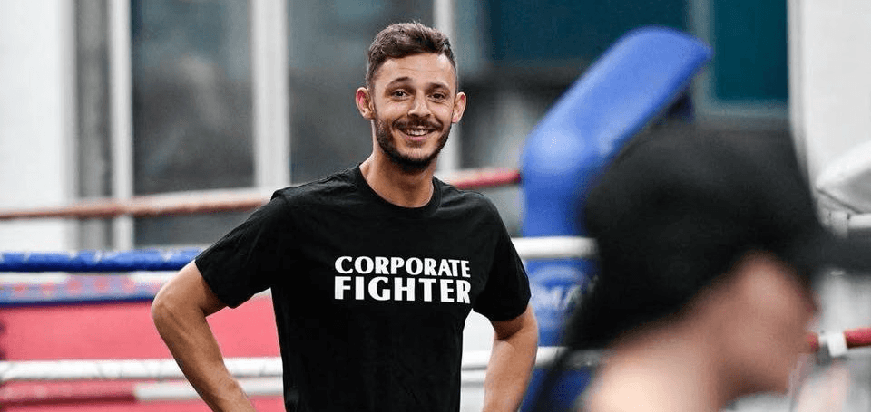 Danilo Dash Creati smiling during a training session, wearing a Corporate Fighter shirt.