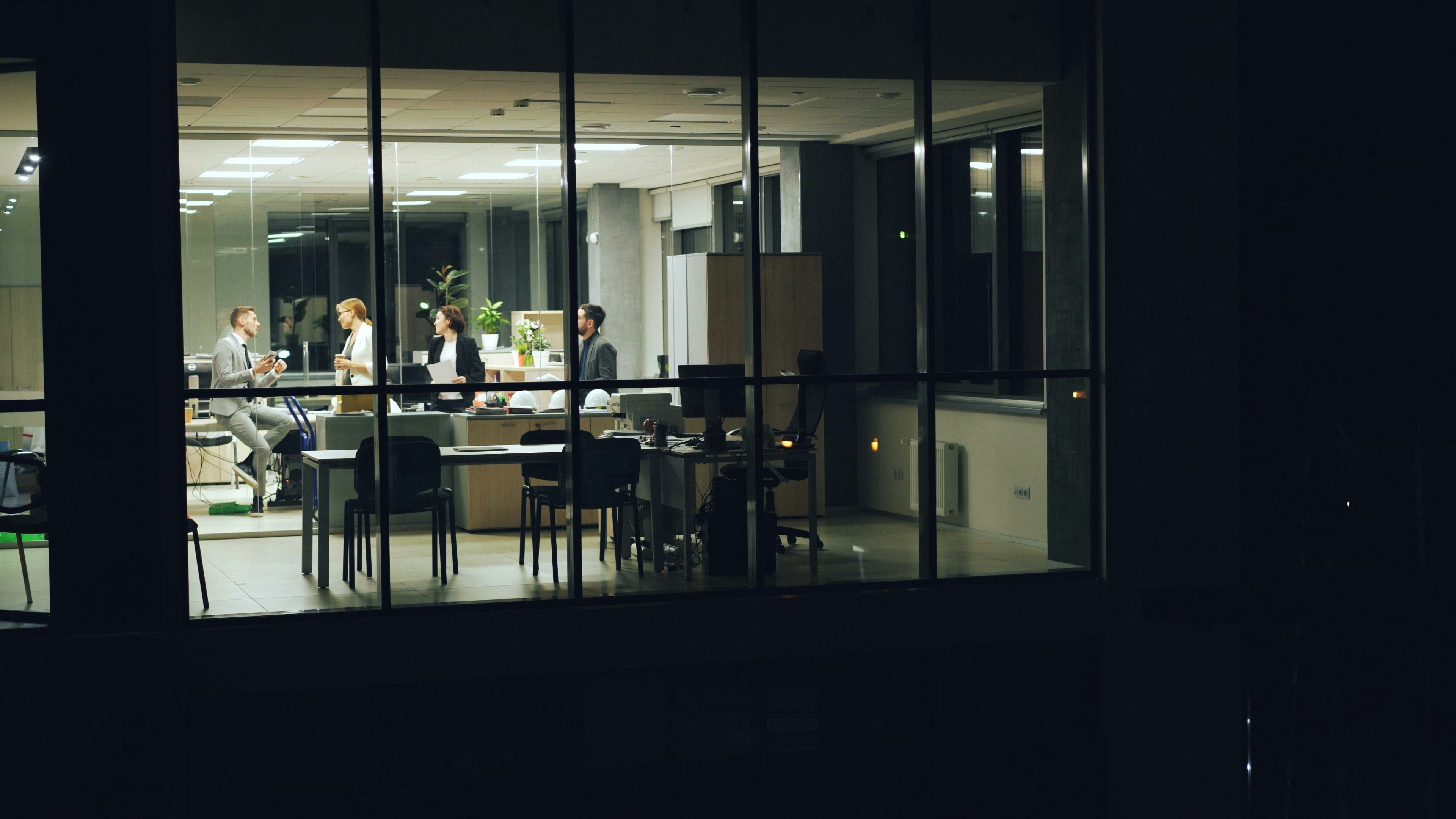 People working late in a modern office at night