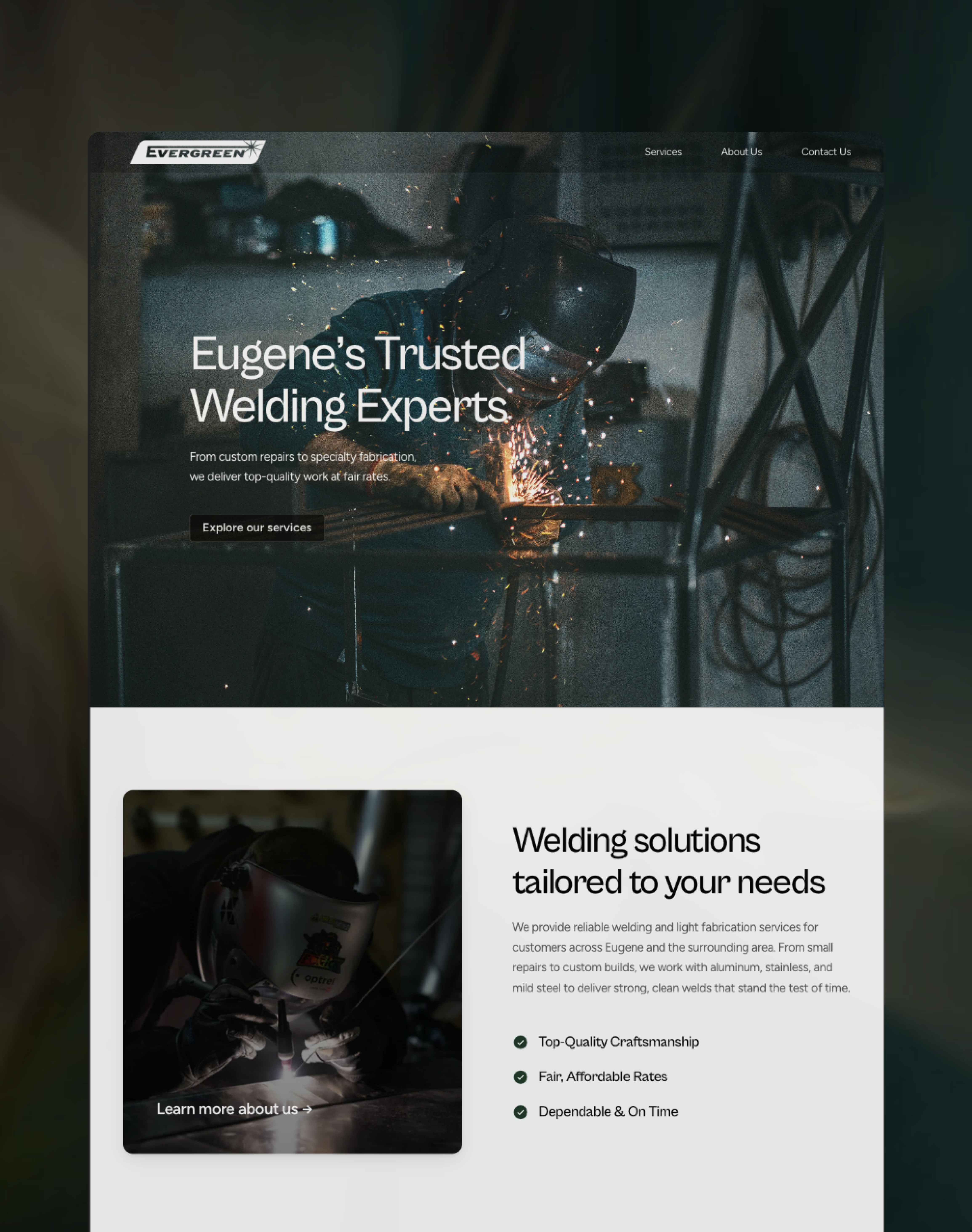 A young person with curly hair smiles at the camera while sitting in front of a laptop against a dark background.